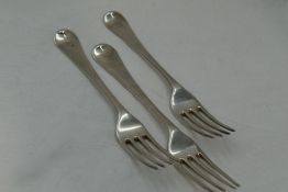 Three Georgian silver table forks of plain form bearing bovine crest to terminals, London 1786,