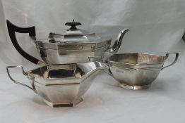 An Art Deco style silver three piece breakfast set of plain elongated hexagonal form having hard
