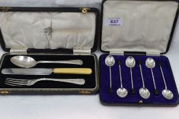 A cased set of six silver coffee spoons having coffee bean knops, Sheffield 1932, Walker & Hall, and