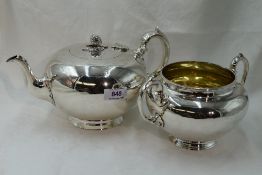 A Victorian silver teapot of plain compressed circular form having melon and leaf knop and