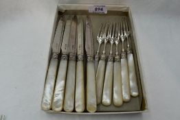 A part set of silver dessert knives and forks having engraved blades and mother of pearl handles,