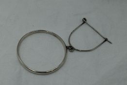 An early 20th Century silver slave bangle with attached clip, Chester 1922, Charles Horner