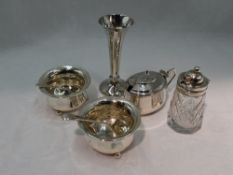 A selection of HM silver including a pair of circular salts with trefoil bun feet, an oval lidded