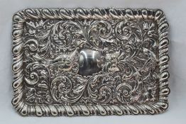 An Edwardian silver dressing table tray of rectangular form having embossed mask, scroll and bird