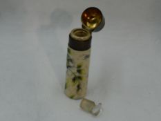 A Victorian ceramic scent bottle having floral and gilt heightened painted decoration, glass stopper