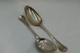 A pair of George II silver table spoons of hanovarian form having fan pattern to reverse of bowls