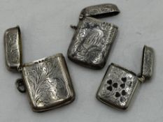 Two Edwardian silver vestas having scroll decoration and monogrammed cartouches, Birmingham 1901/03,