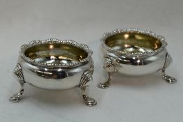 A pair of Georgian silver open salts having trefoil hoof feet and shaped rims, London 1752, makers