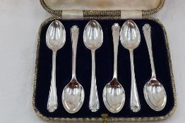A cased set of six silver teaspoons having golf interest to terminals, Sheffield 1933, Walker &
