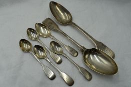 Five Victorian silver teaspoons of fiddle back form bearing monograms to terminals, a Georgian