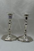 A pair of Edwardian silver candle sticks of octagonal form having removable sconces, shaped
