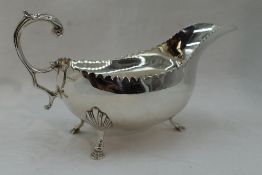 An Irish silver sauce boat having indented rim, loop handle & trefoil hoof feet, Dublin 1971,
