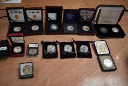 A collection of Silver Coins and Medallions in cases and plastic cases including 5 Pound Coins South