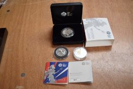 A 2017 2 Pound 1oz Silver Britannia Coin in case, a 50 Pound 2015 Silver Britannia Coin and a 5