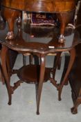 An early 20th Century mahogany occasional table having shaped top and undertier