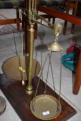 A set of vintage brass balance scales, on mahogany base