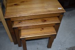 A modern pine nest of three tables