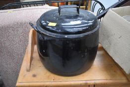 A traditional travel or stove cooking pot in black enamel