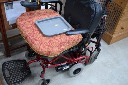 An electric mobility scooter , powered by Phisghang, and a walking aid