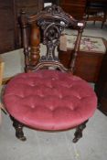 A Victorian nursing chair having pink dralon button seat