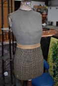 A vintage dressmakers dummy , female form,on wooden tripod base