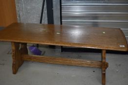 A modern oak coffee table, Ercol style, approx. 122 x 47cm