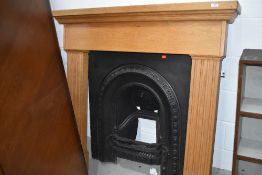 A reproduction cast fire place,and wooden surround