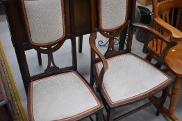 An Edwardian mahogany and inlaid salon armchair and matching chair