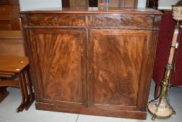 A Victorian flame mahogany bookcase base or sideboard, width approx. 120cm