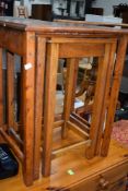 A vintage oak nest of three tables
