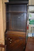 A stained frame Arts and Crafts style narrow bookcase with cupboard under, width approx. 71cm Height