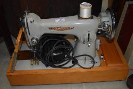 A vintage Seamstress electric sewing machine, in case