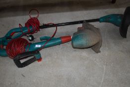 Two electric grass strimmers