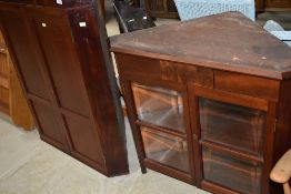 A craftsman made mahogany corner cupboard having display base