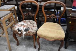 Two Victorian balloon back dining chairs having carved detailing