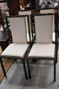 A set of four modern metal (black and gilt) upholstered dining chairs