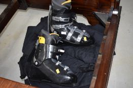 A pair of skiboots and suit