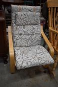 A modern ply Ikea style chair, with cream pattern upholstery, very clean