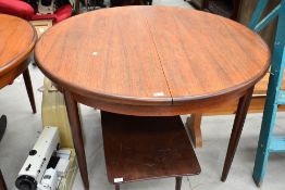A vintage teak G plan or similar circular extending dining table, diameter approx. 122cm