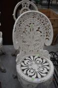 A cast aluminium garden chair, in classical coalbrookdale style