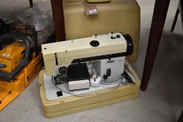 A vintage Pfaff 294 electric sewing machine with moulded plastic case