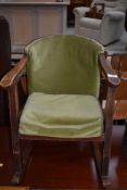 A vimtage childrens stained frame and dralon rocking chair