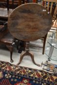 A 19th Century tilt top pedestal table on triple splay legs, in need of restoration