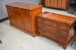 A reproduction yew wood sideboard and entertainment unit modelled as a chest of drawers