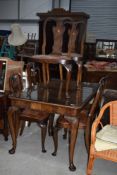 A mid 20th Century dining table and four chairs, on cabriole legs, approx. 136 x 93cm