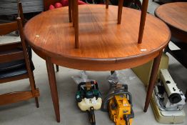 A vintage teak G plan or similar circular extending dining table, diameter approx. 122cm