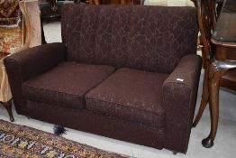 A 1930s settee with original metal casters, finished in brown moquette , good solid frame for a re