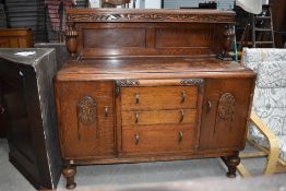 A mid 20th Century oak sideboard having ledge back ( loose leg)