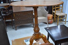 A Victorian satinwood occasional table having oval top on turned column and triple splay base, width