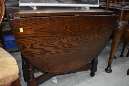A modern drop leaf dining table with a dark oak stain